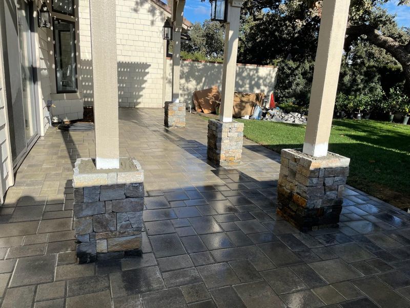 Covered paver patio with three columns on new stacked-stone bases