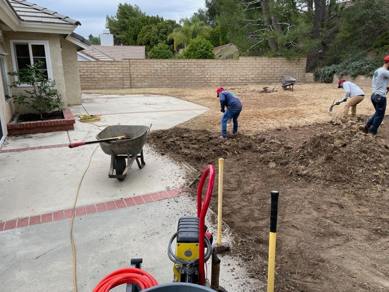 Our crew digging out a dead lawn with shovels before the rebuild