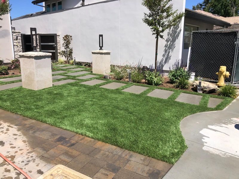 Front yard with artificial turf, a paver stepping path and new planting beds